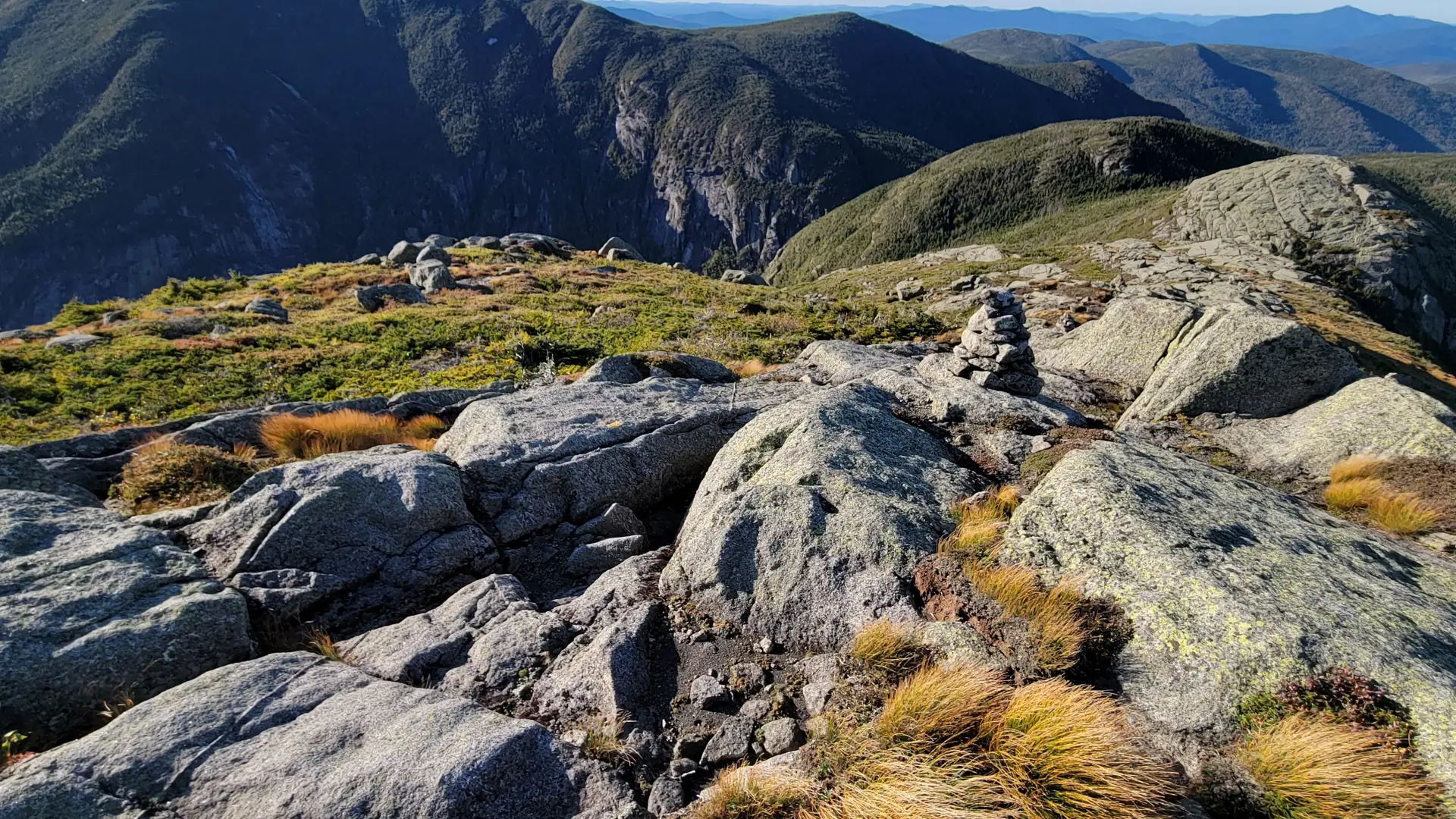 A view from a rocky summit into a deep gorge
