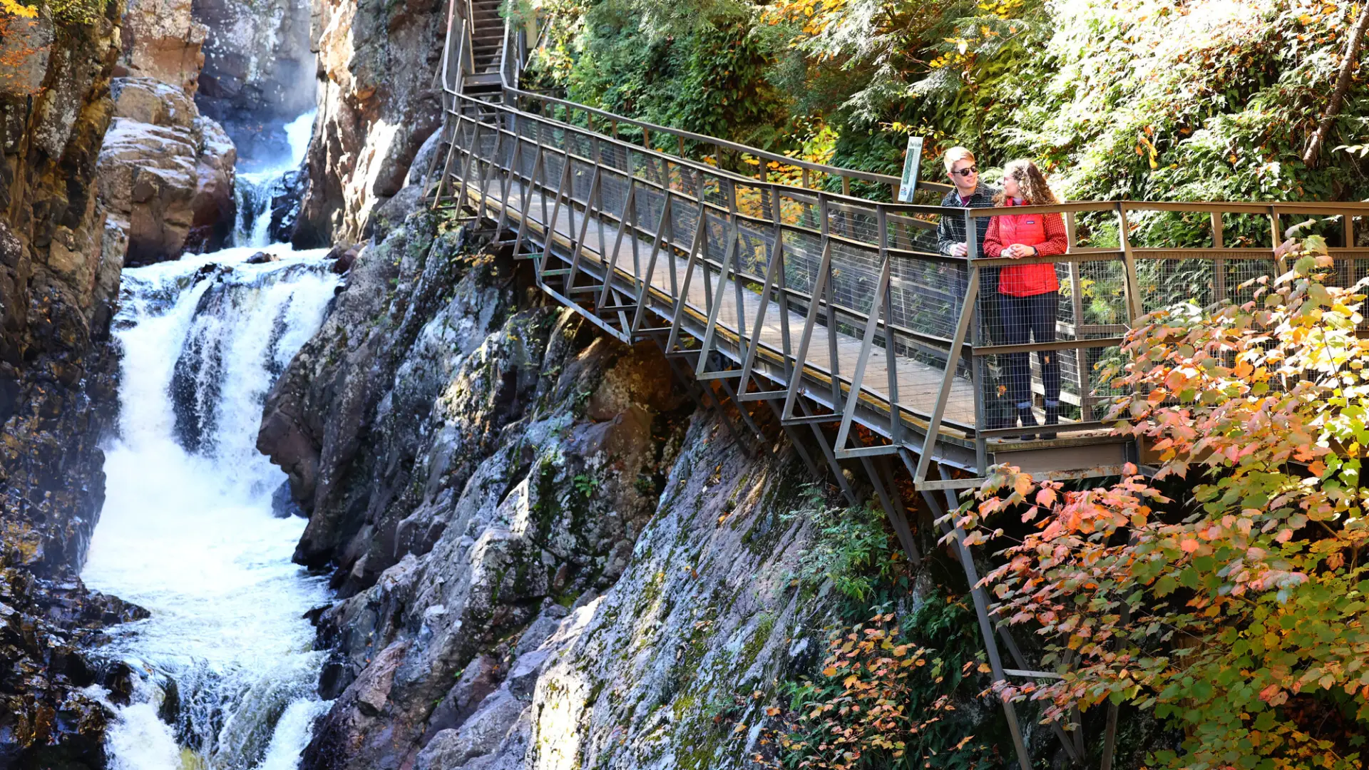 A couple walking at High Falls Gorge during the fall.