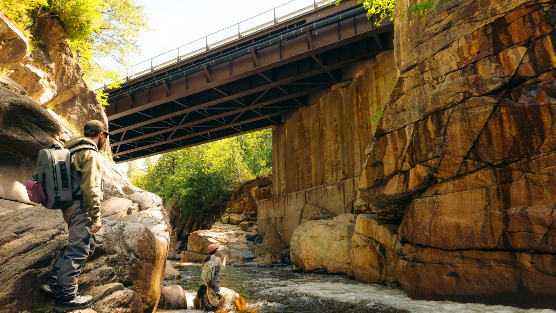 A flyfisher underneath a bridge