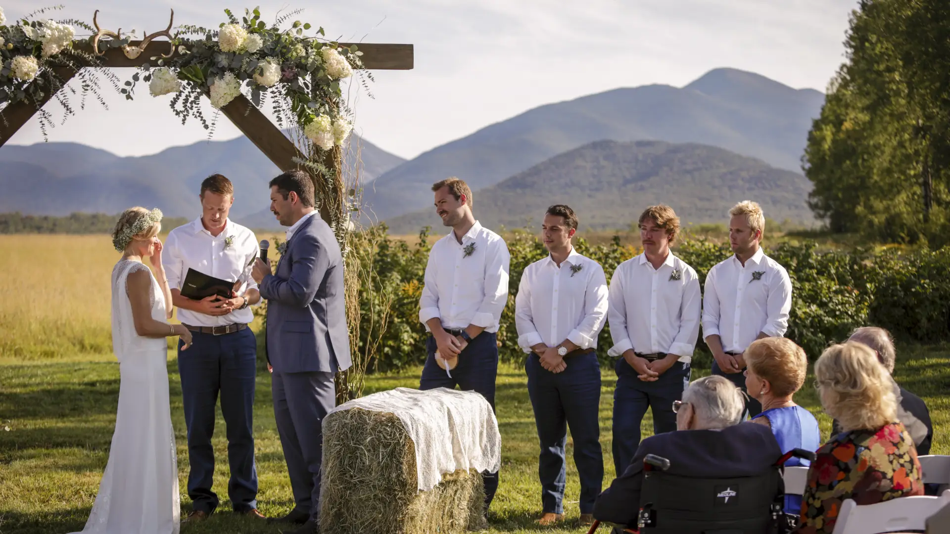 Bride and Groom at the alter with groomsmen and mountains surrounding.