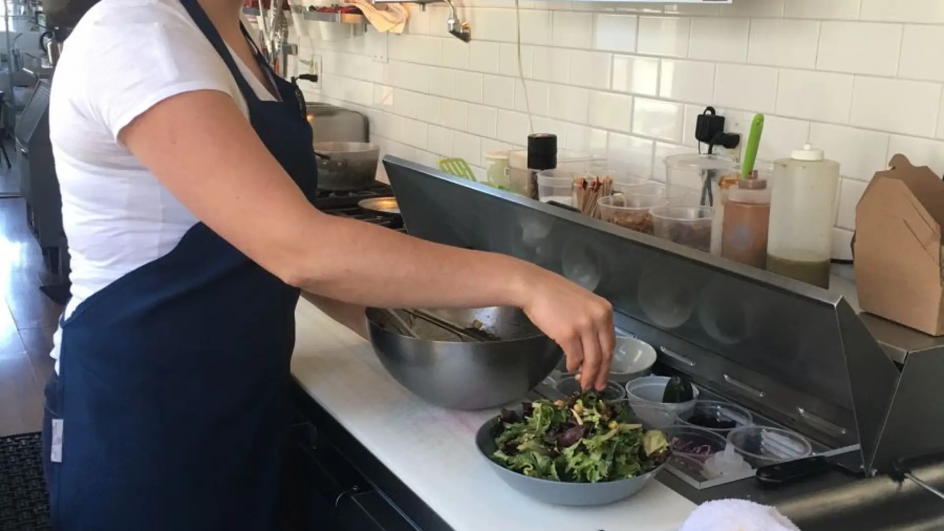 Kayte puts the finishing touches on a delicious, delicious house salad.