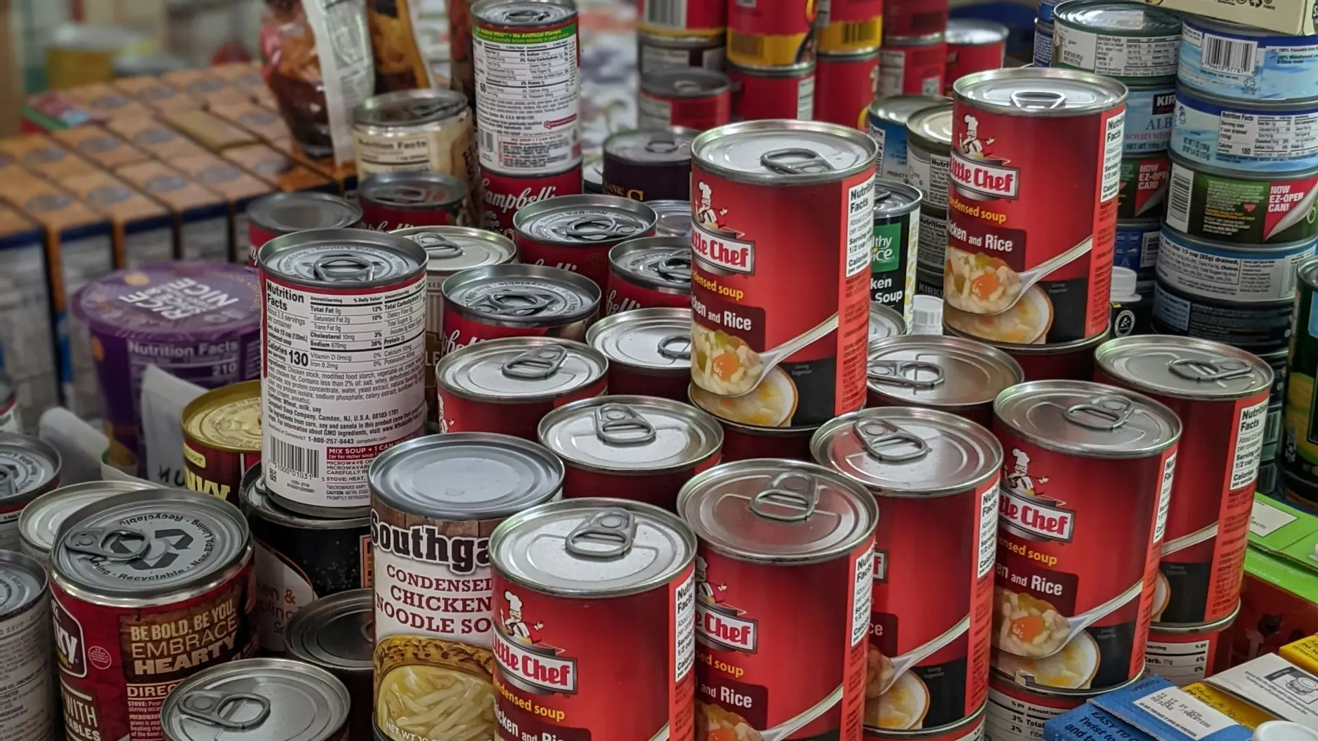 Cans of food and dry goods stacked on a table