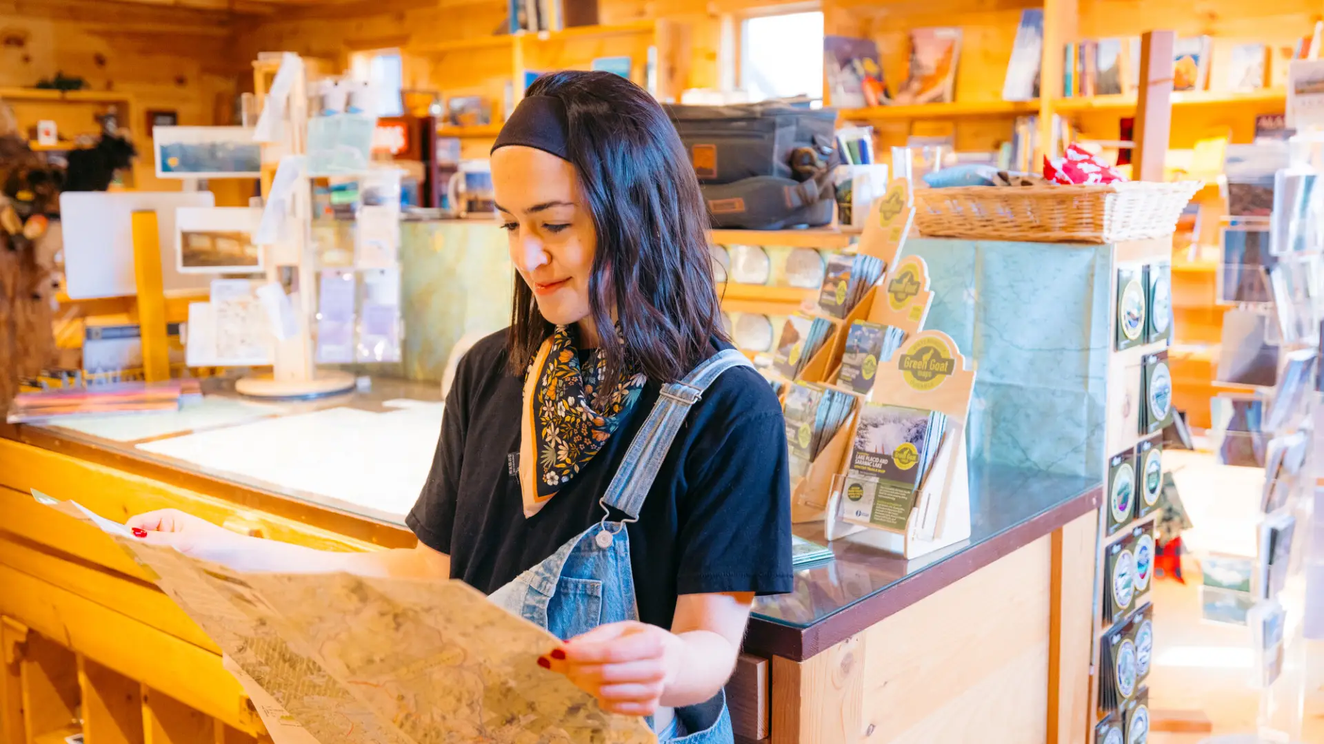 A woman looks at a map in a gear store