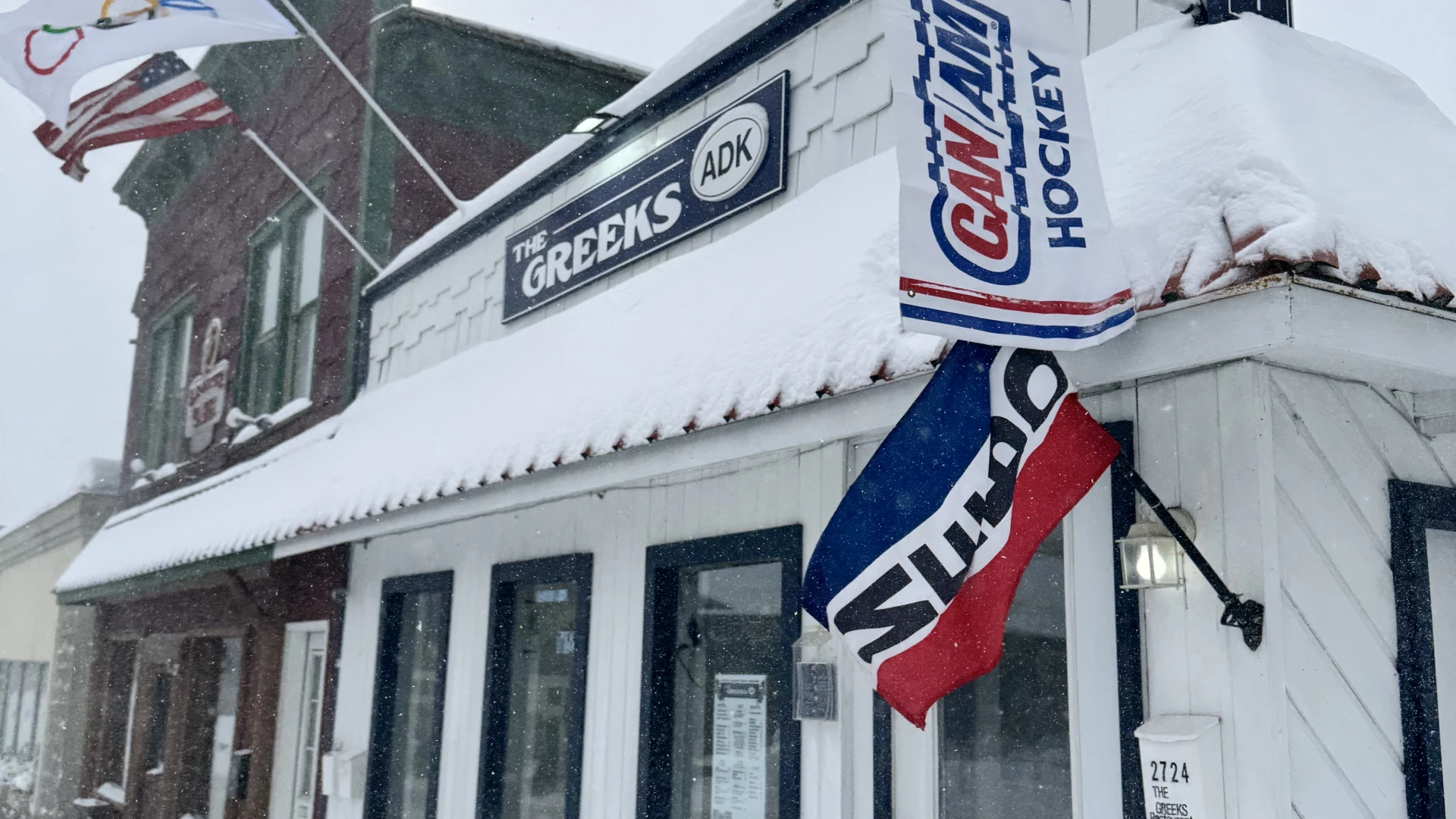 The exterior of The Greeks ADK blanketed in fresh snow - open year round!