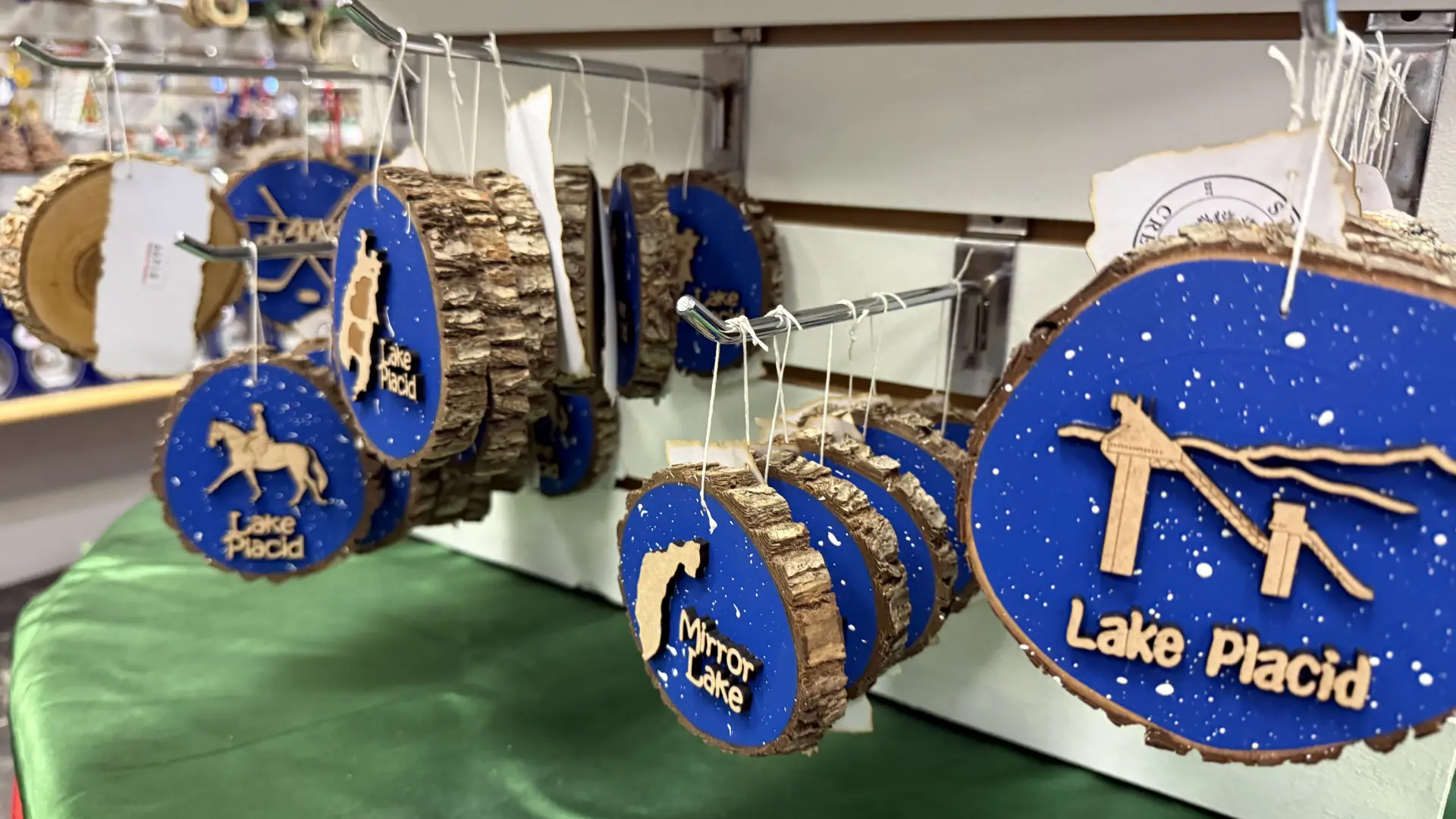 Lake Placid themed log cookie ornaments with ski jumps and people riding horses