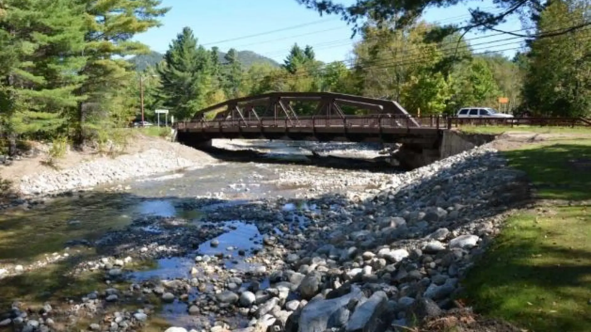 A metal bridge over a rocky river