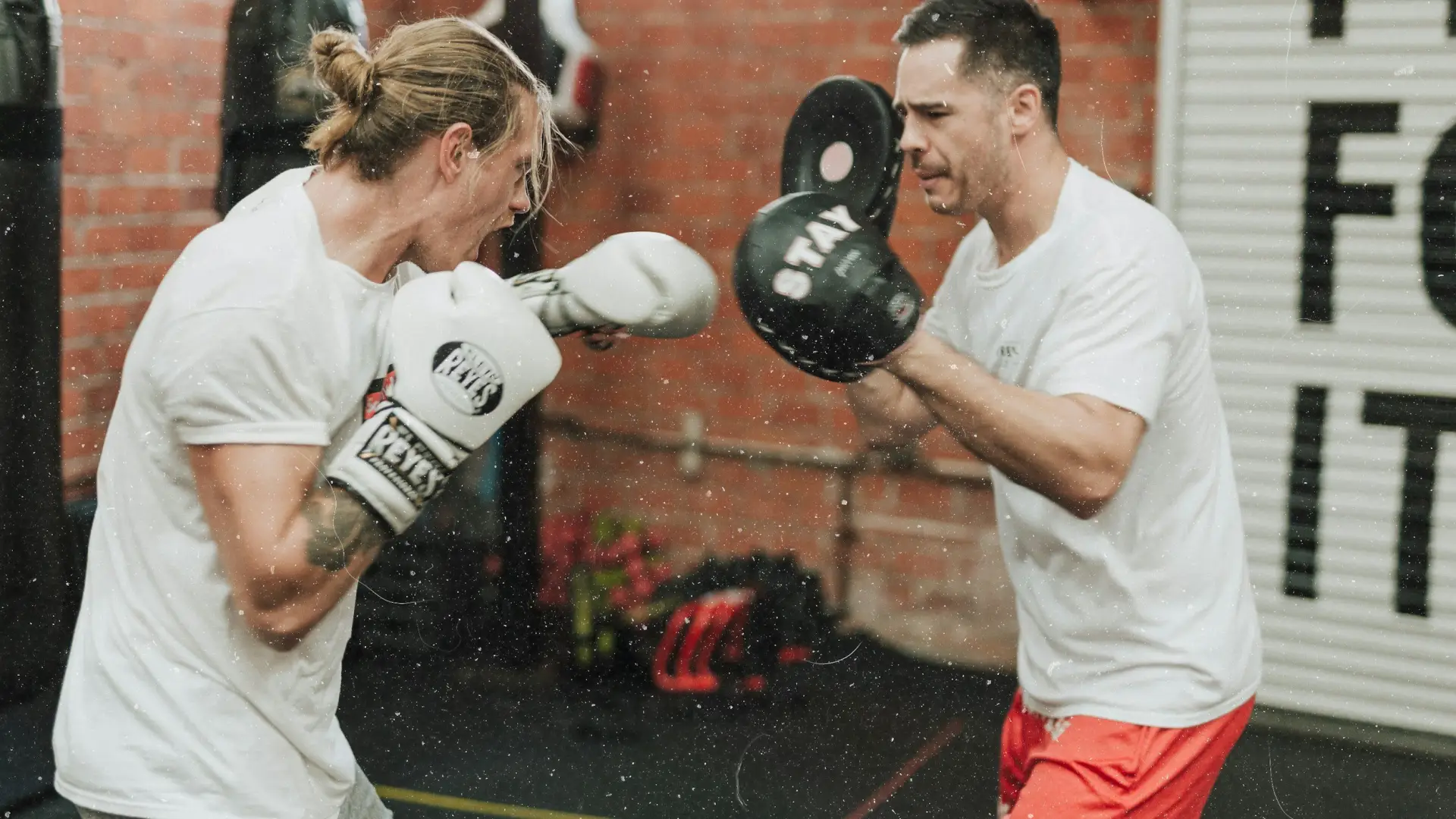 Two people sparring in a boxing ring.