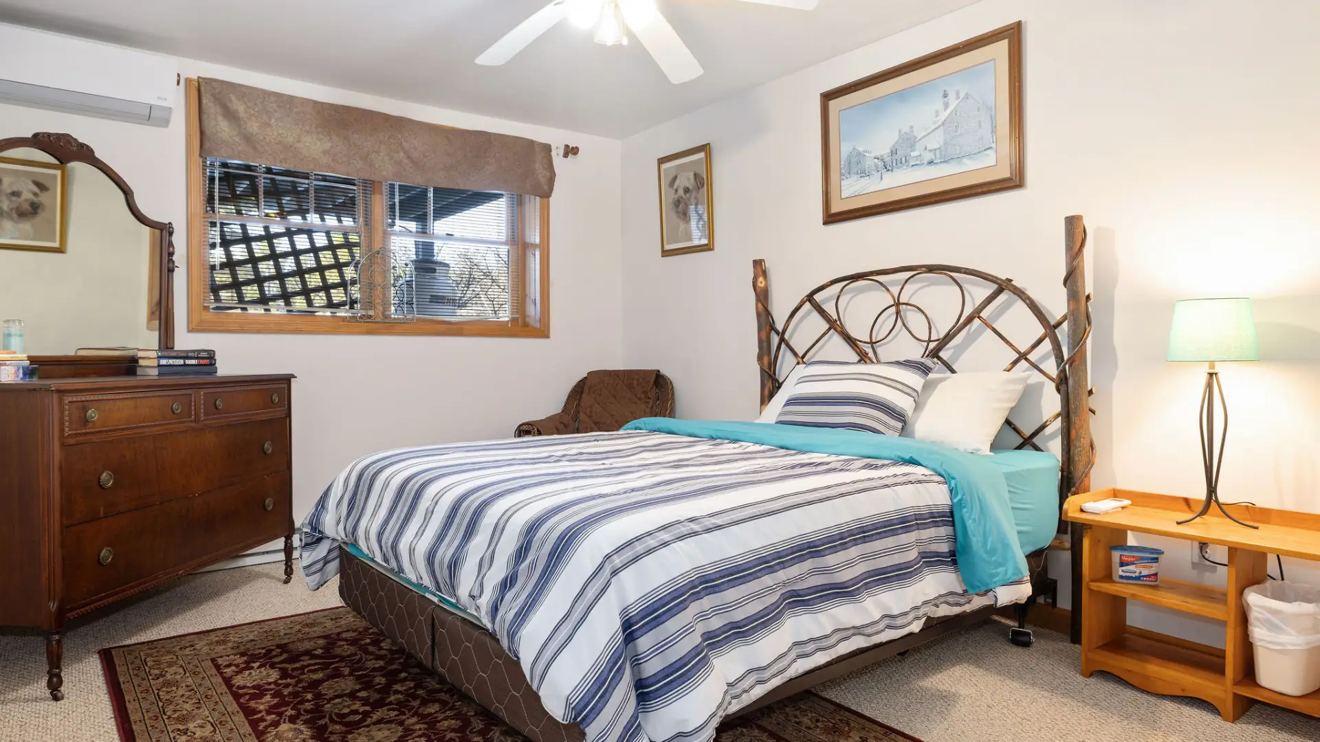 A lower level bedroom with blue striped sheets at the crib at Lake Placid Pinehill Townhouse.