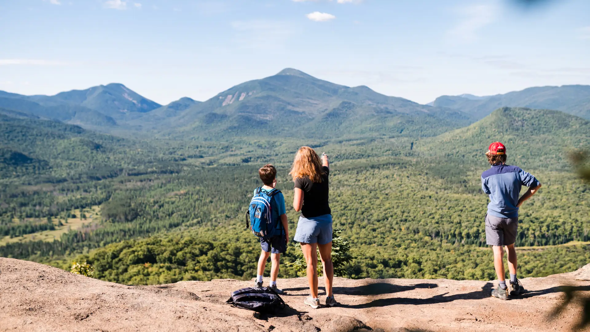 A family looks out to mountains. 