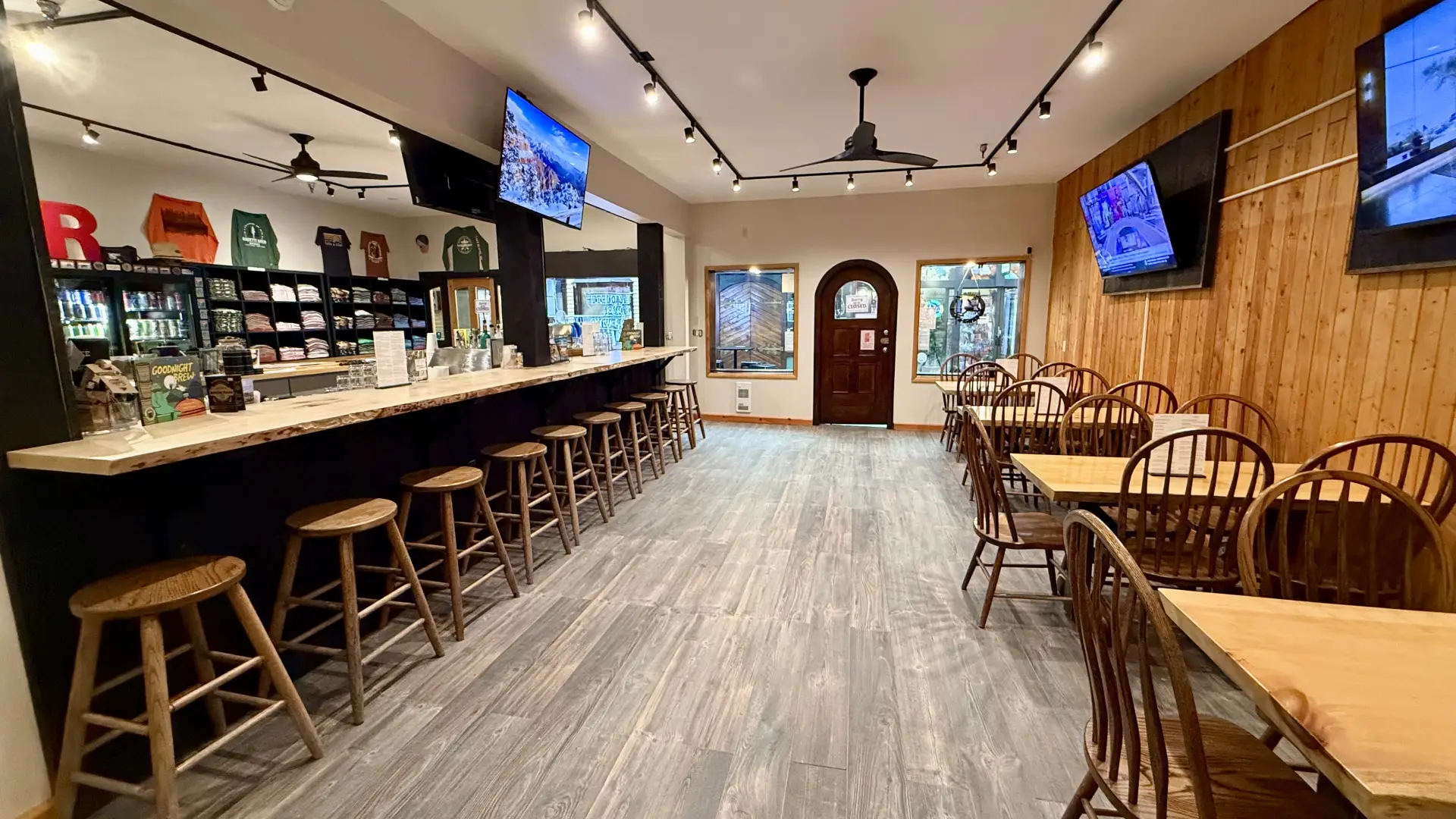 Large space with dining tables and chairs opposite the bar area at Raquette River Brewing Taproom.