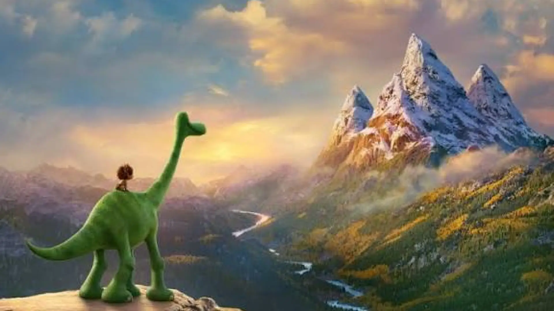 Screenshot from The Good Dinosaur movie with boy riding a green dinosaur looking over a valley at tall mountains
