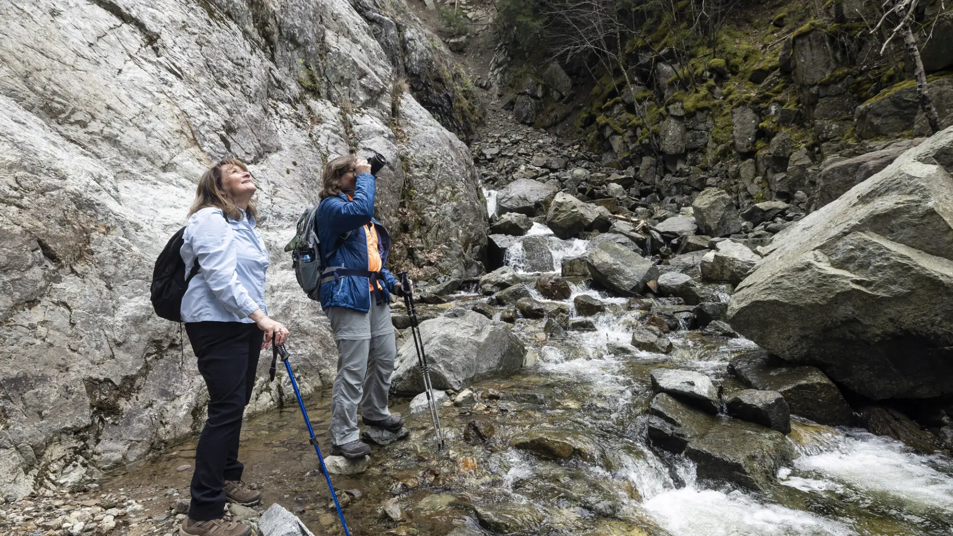 Two woman near a waterfall