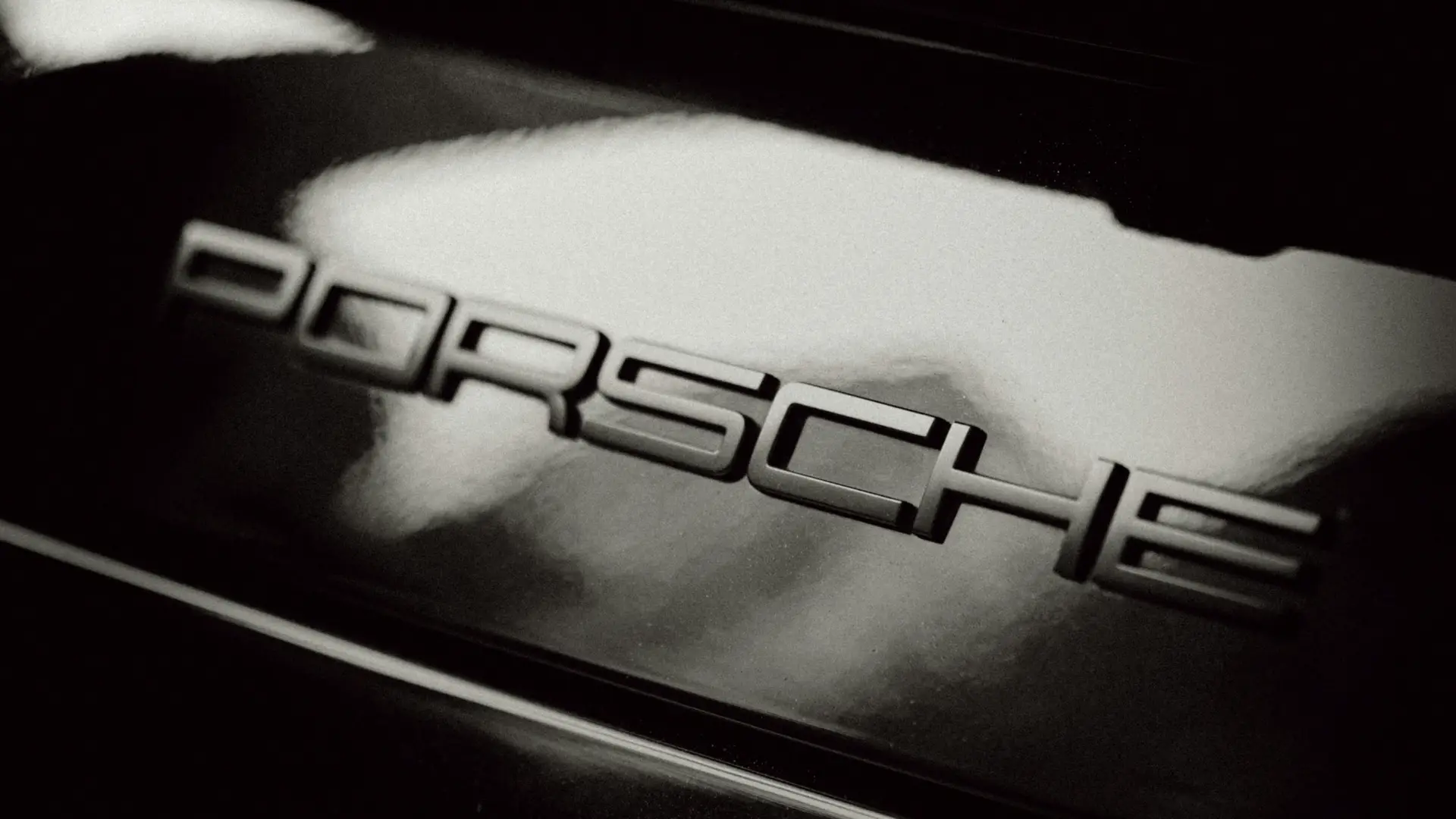 Close-up of Porche name on part of car exterior
