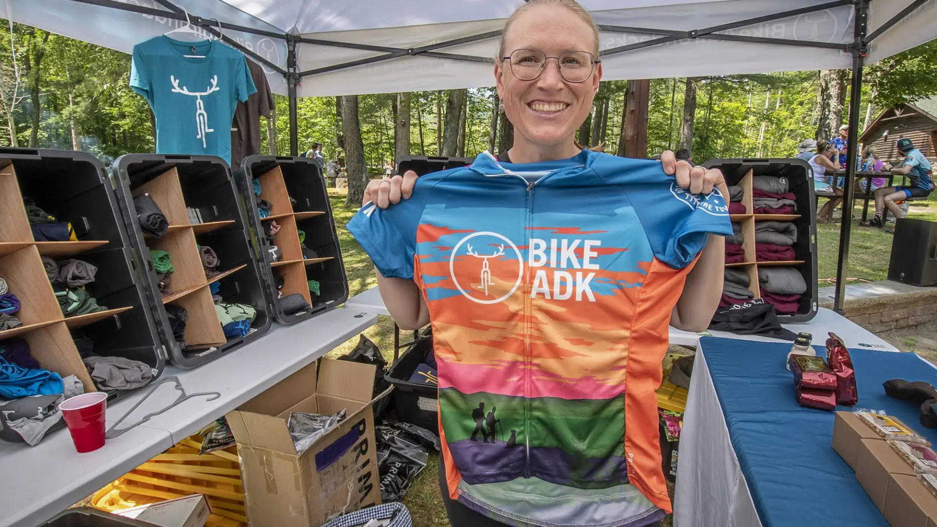 Event participant holds up race jersey