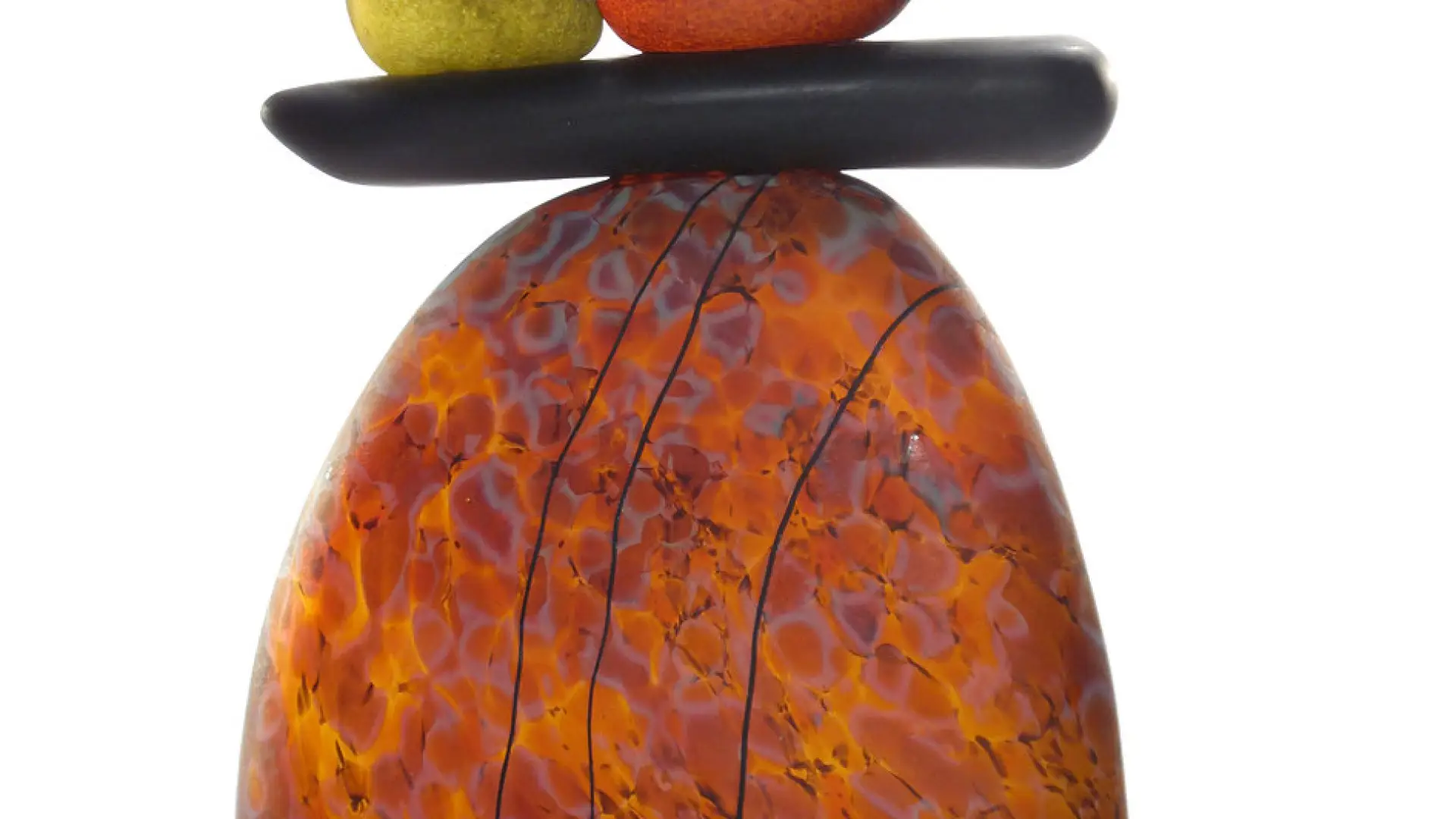 Larger orange rock balances flat black rock which then balances three more rocks