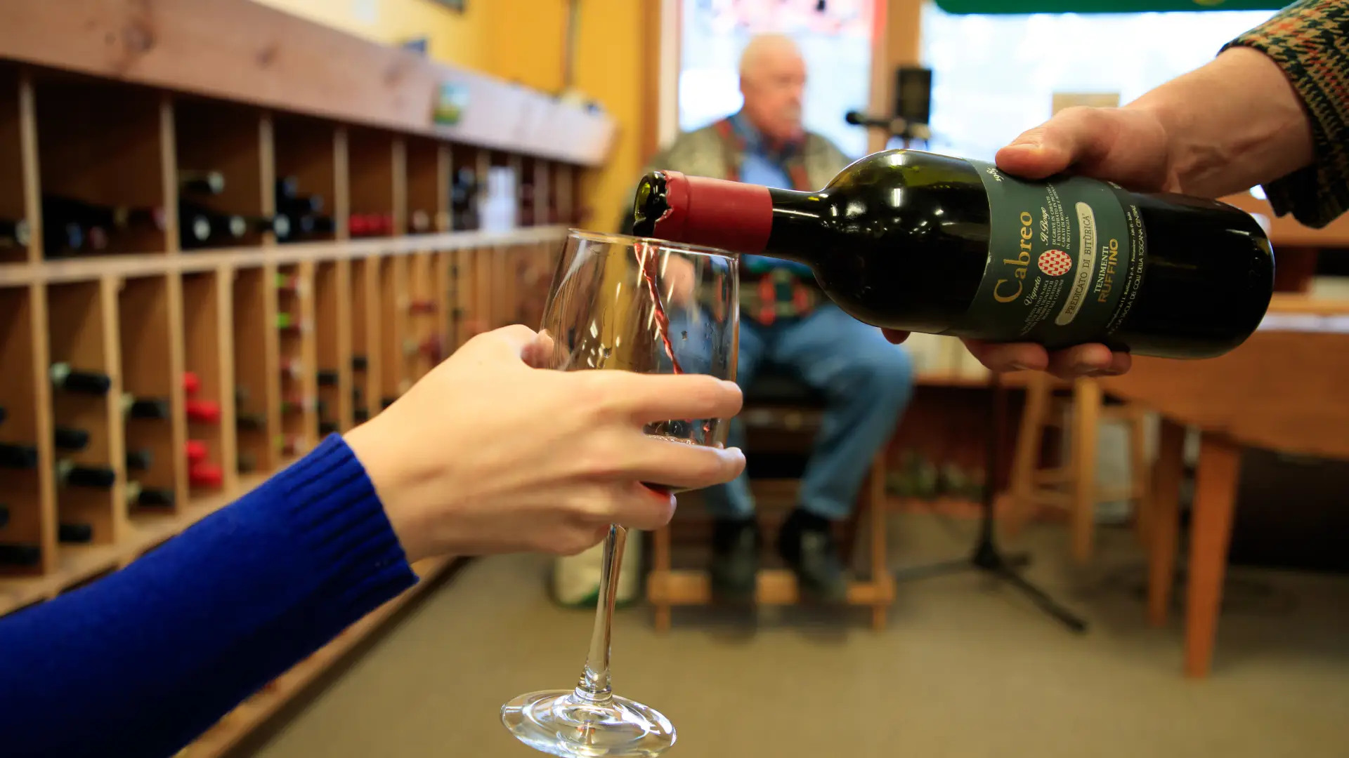 Wine being poured into a glass at a Lake Placid wine shop.