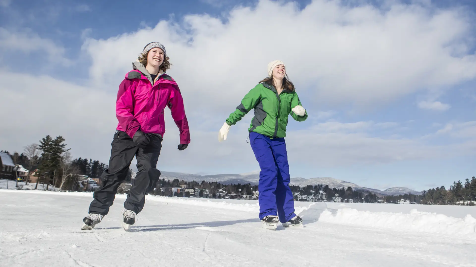 two girls skating on the the ice track on Mirror Lake