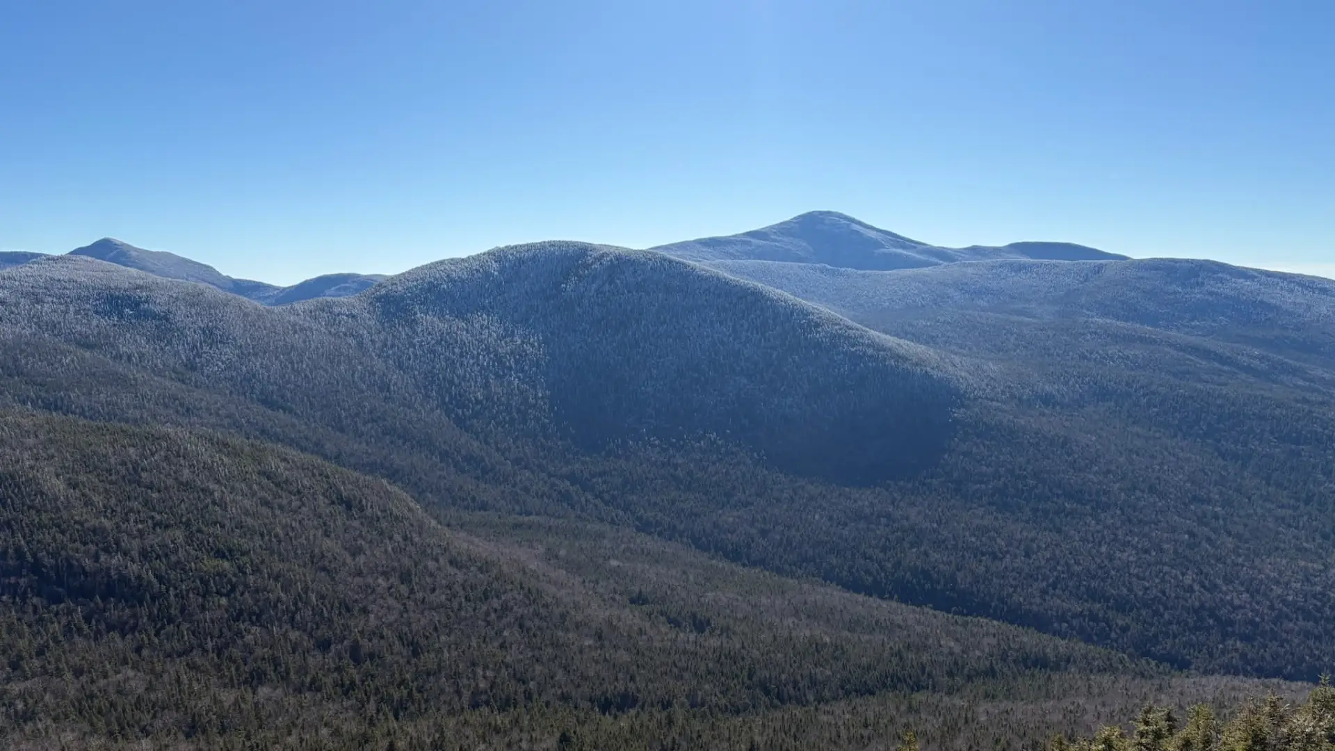 snow caresses the mountain tops