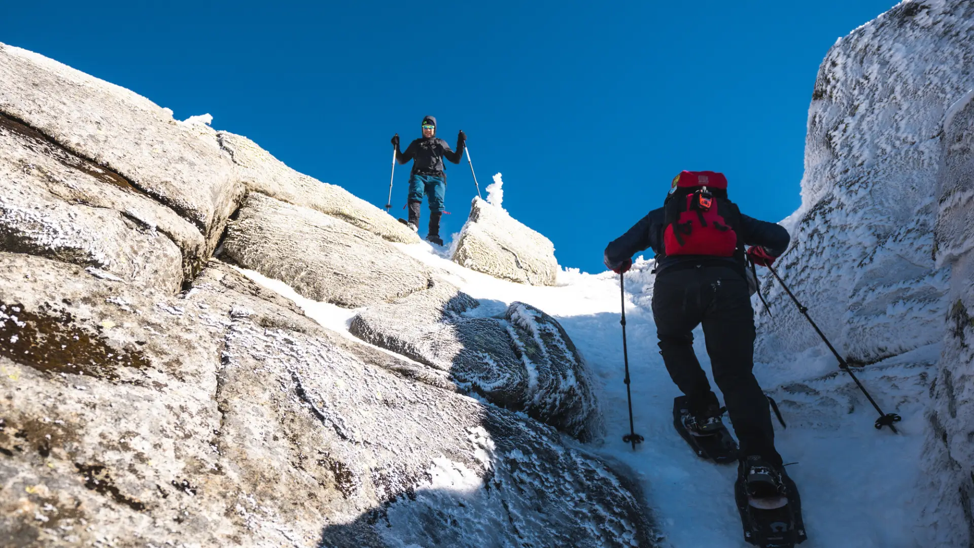 Snowshoers going up a steep rocky area