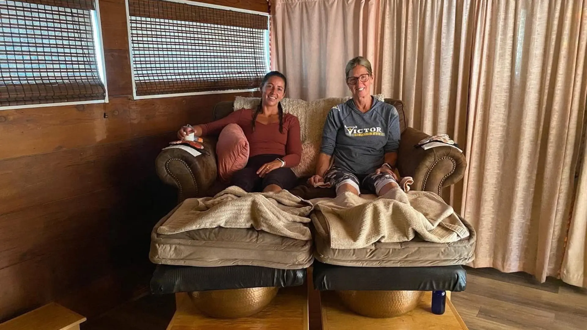 Better Together - two friends happily sit on the warming pedicure chairs