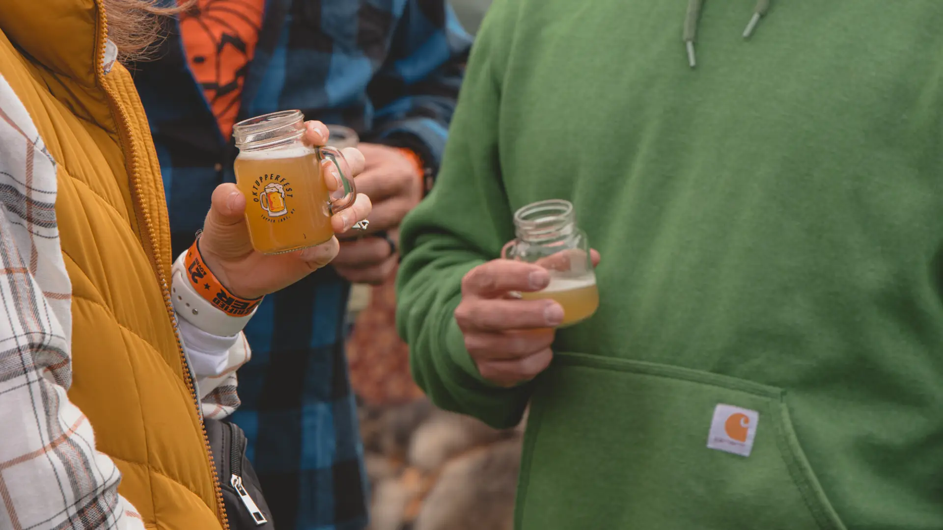 Close up of a couple drinking beer samples at OkTupperfest