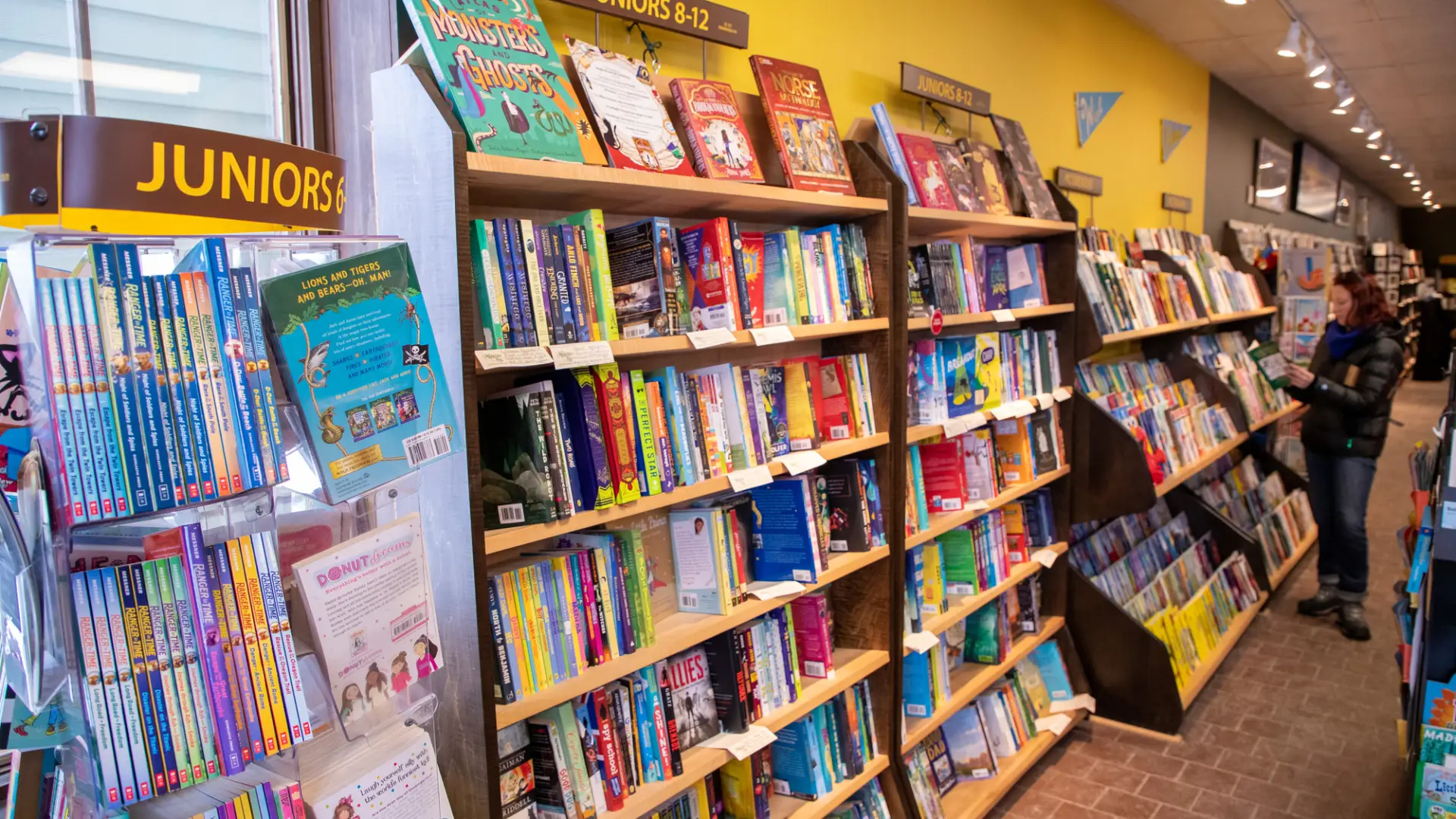 Rows of children's books on bookshelves in bookstore
