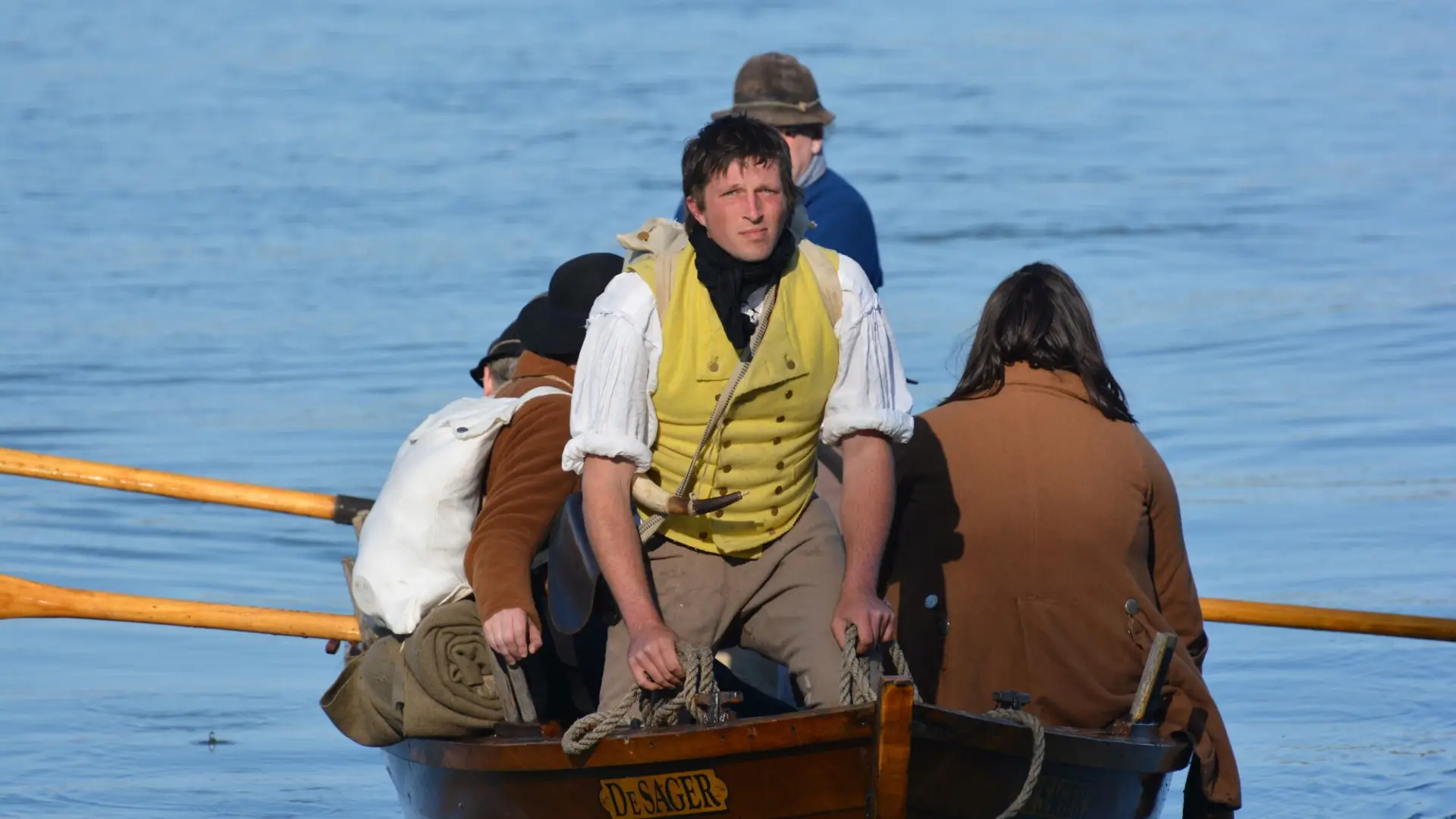 Revolutionary war reenactors float on a small boat