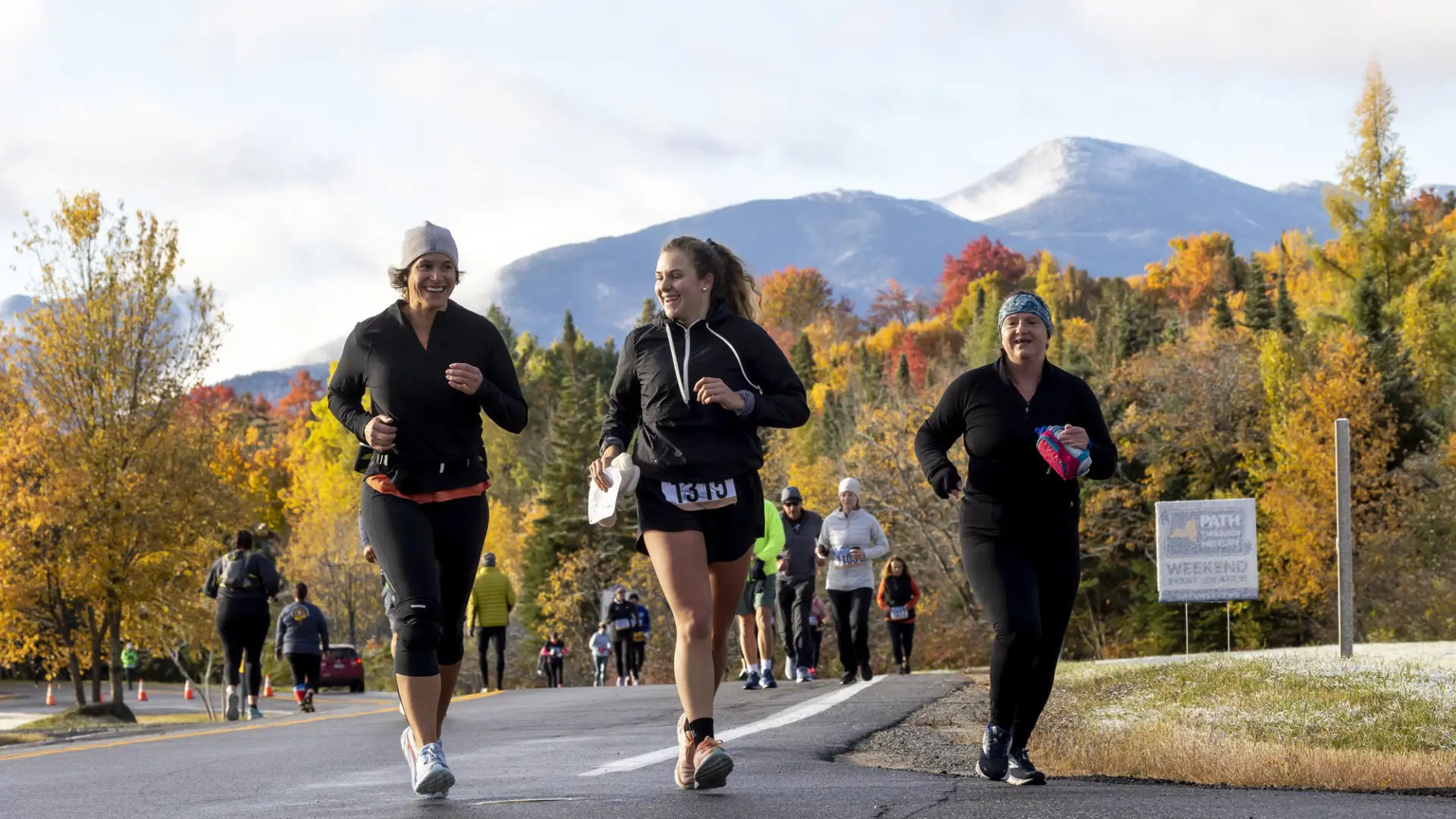 Trio of runners during race with mountains in background