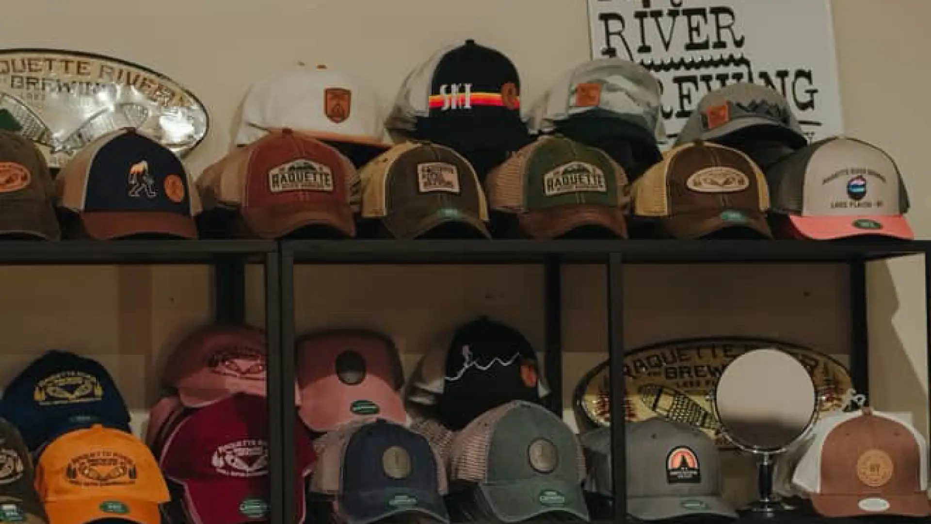 A wall full of branded caps