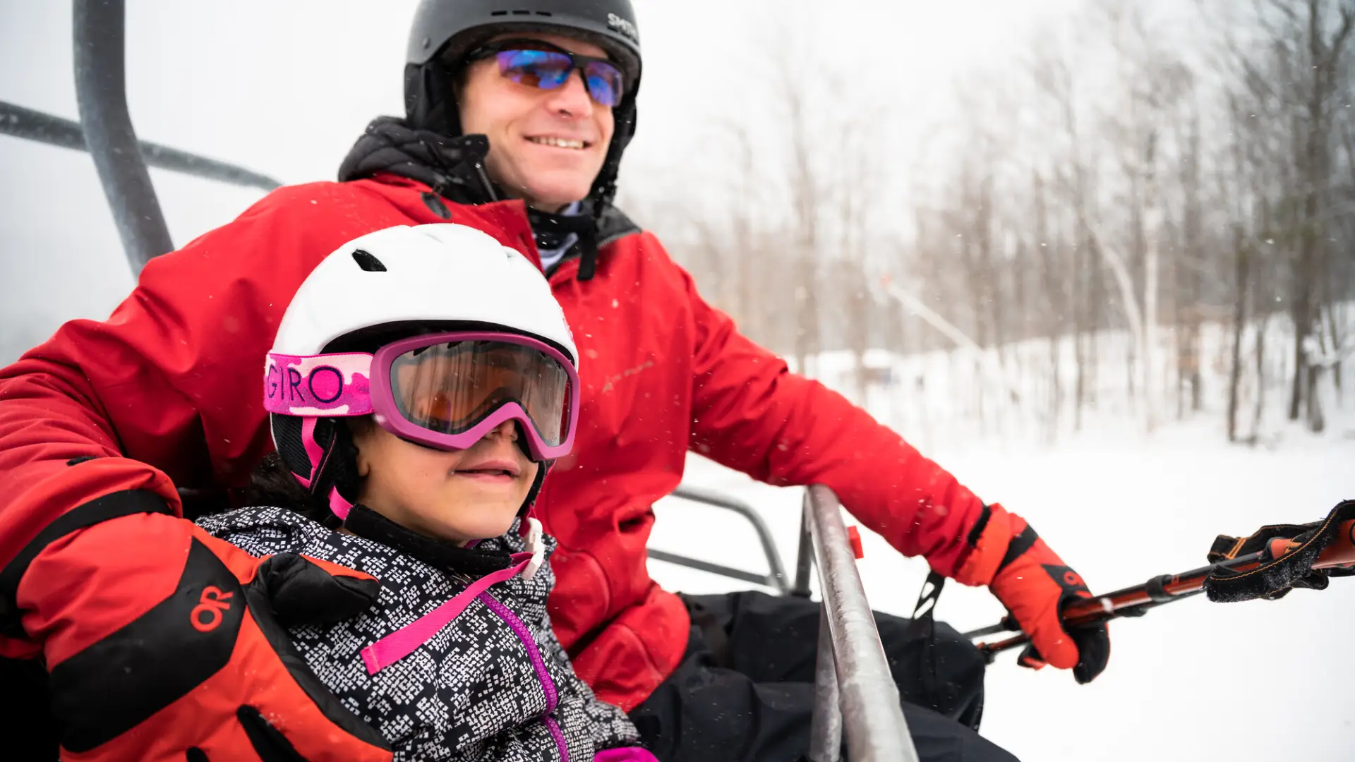 A father-daughter duo on a chair lift