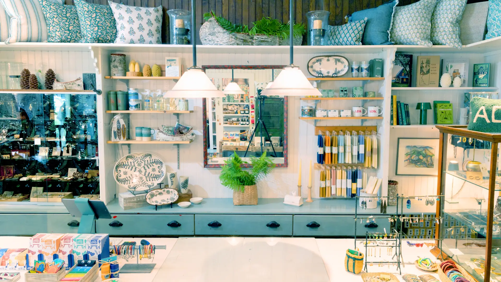 The front counter of The Birch Store with candles, jewelry and baby blue accents