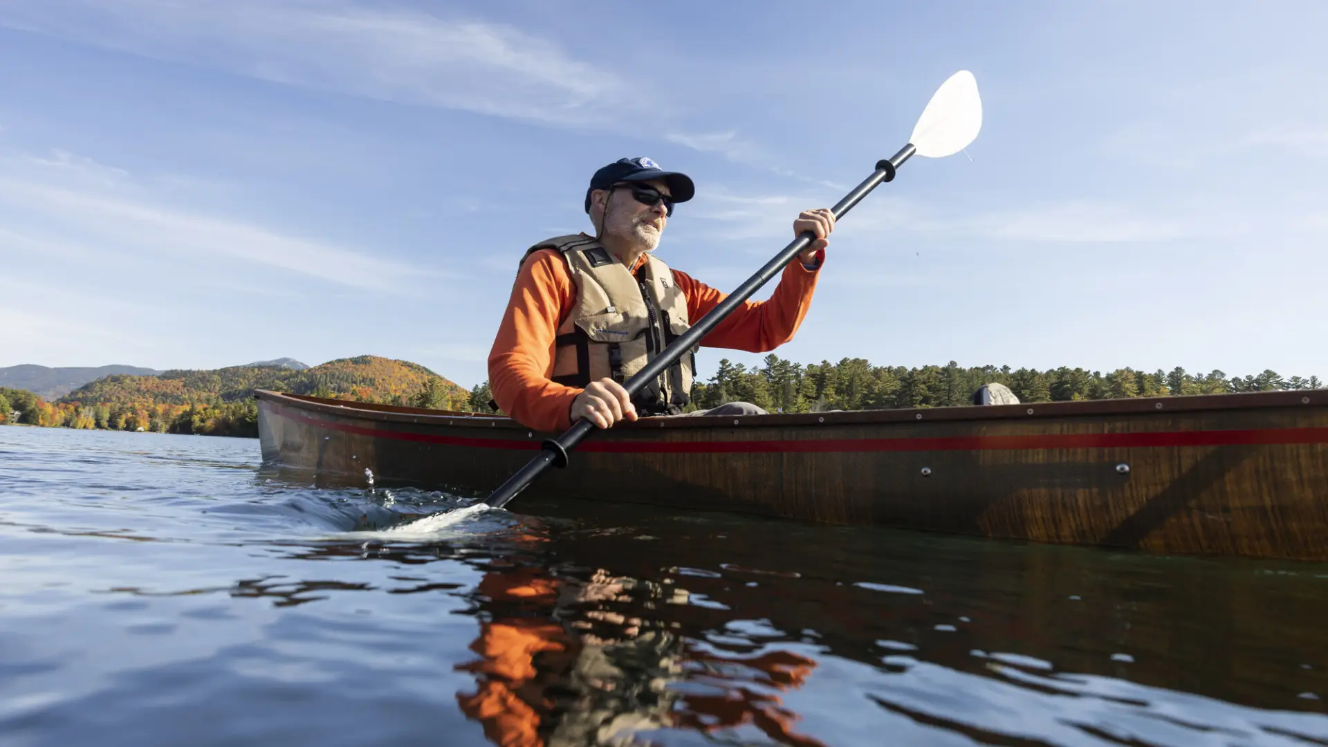 A person paddling in the fall.