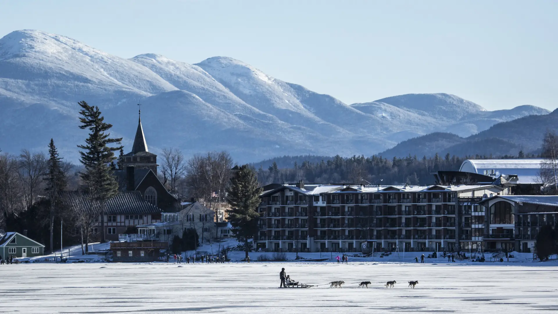 A dog sled team races along a frozen lake. 