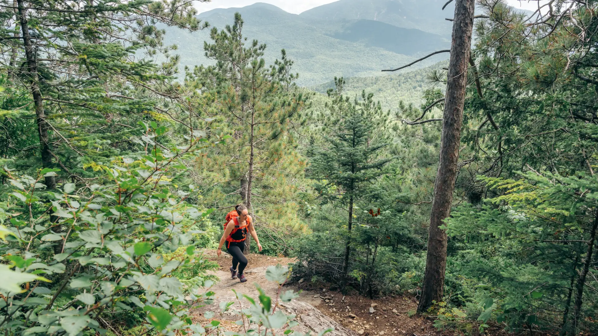 View of mountains with hiker approaching on trail