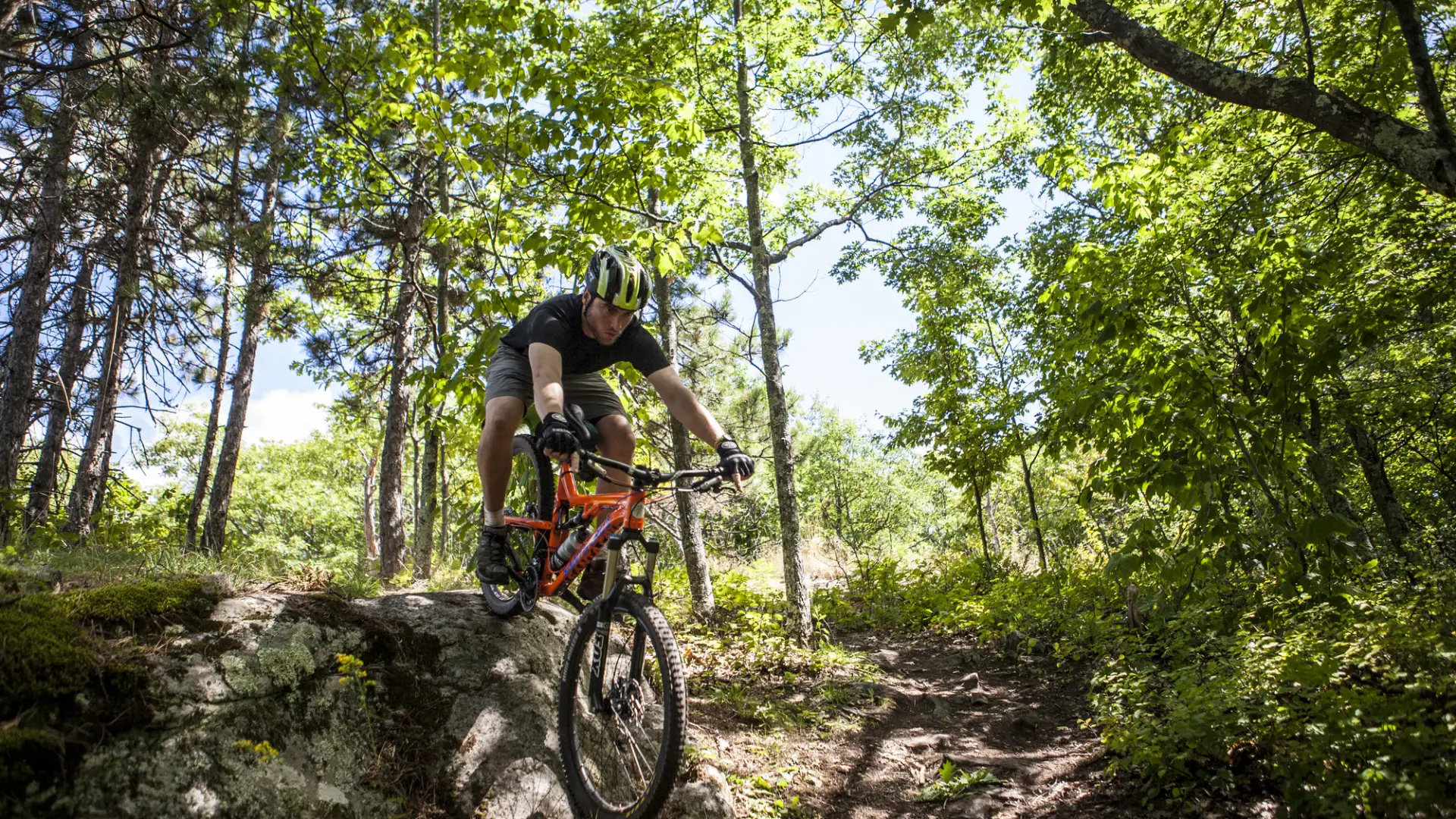 A mountain biker going down rocky terrain