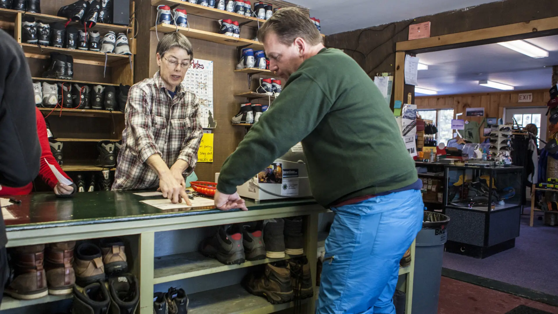A man buys used gear at the welcome center.