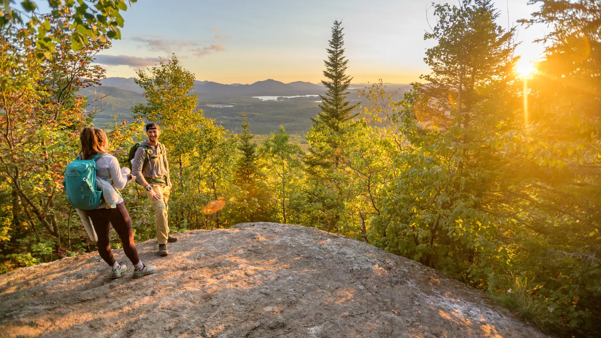 Two people in the last light on a mountain