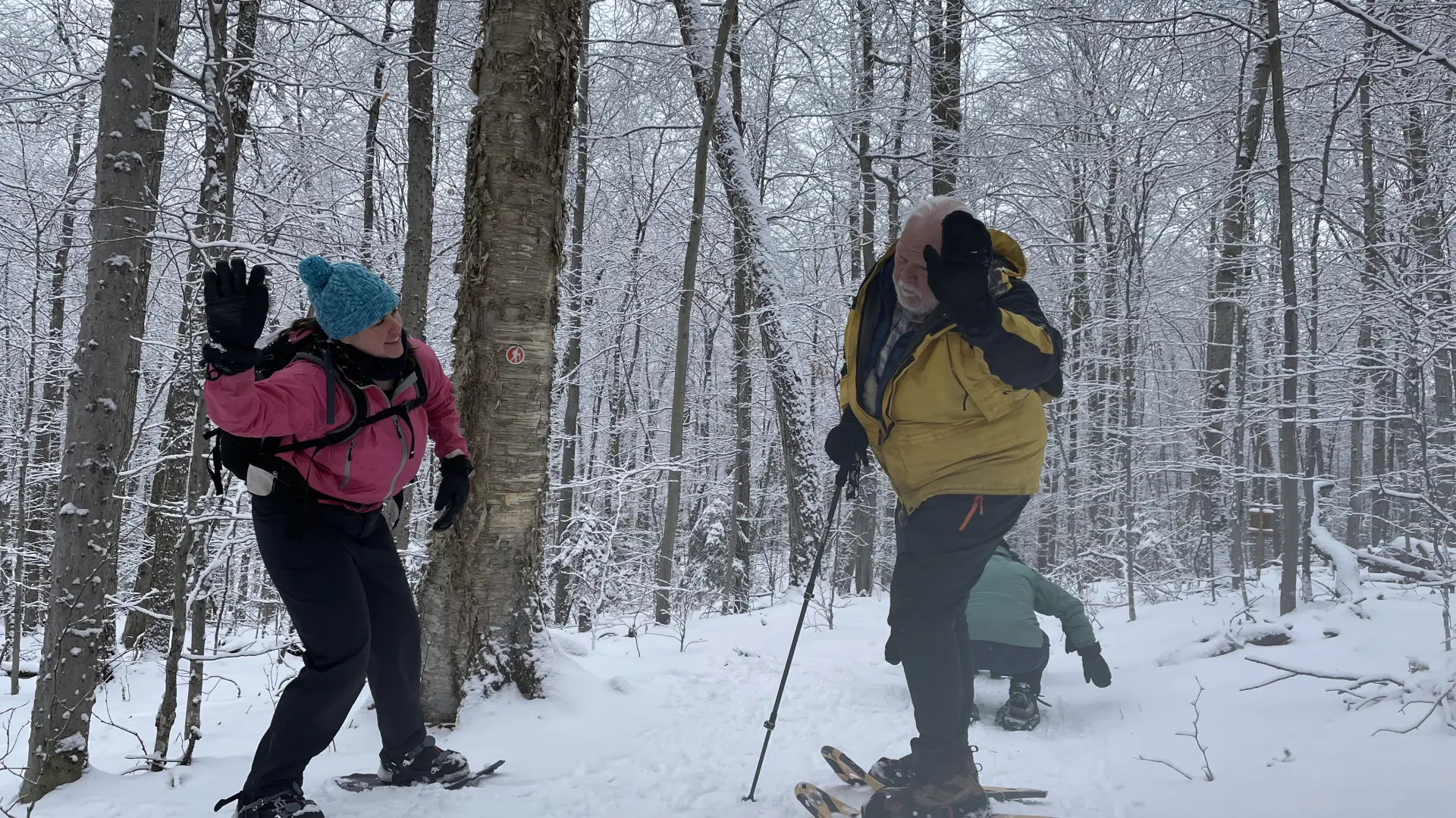 Two snow shoers gear up for a high-five.