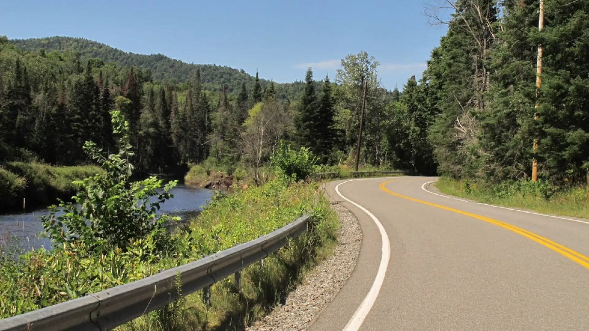 A winding road by a river