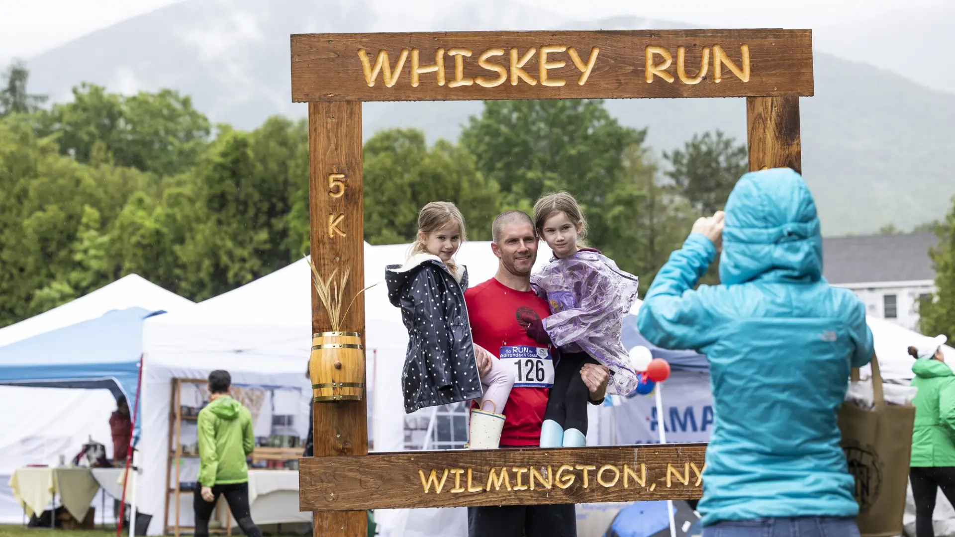 Family taking photo with Whiskey Run photo frame