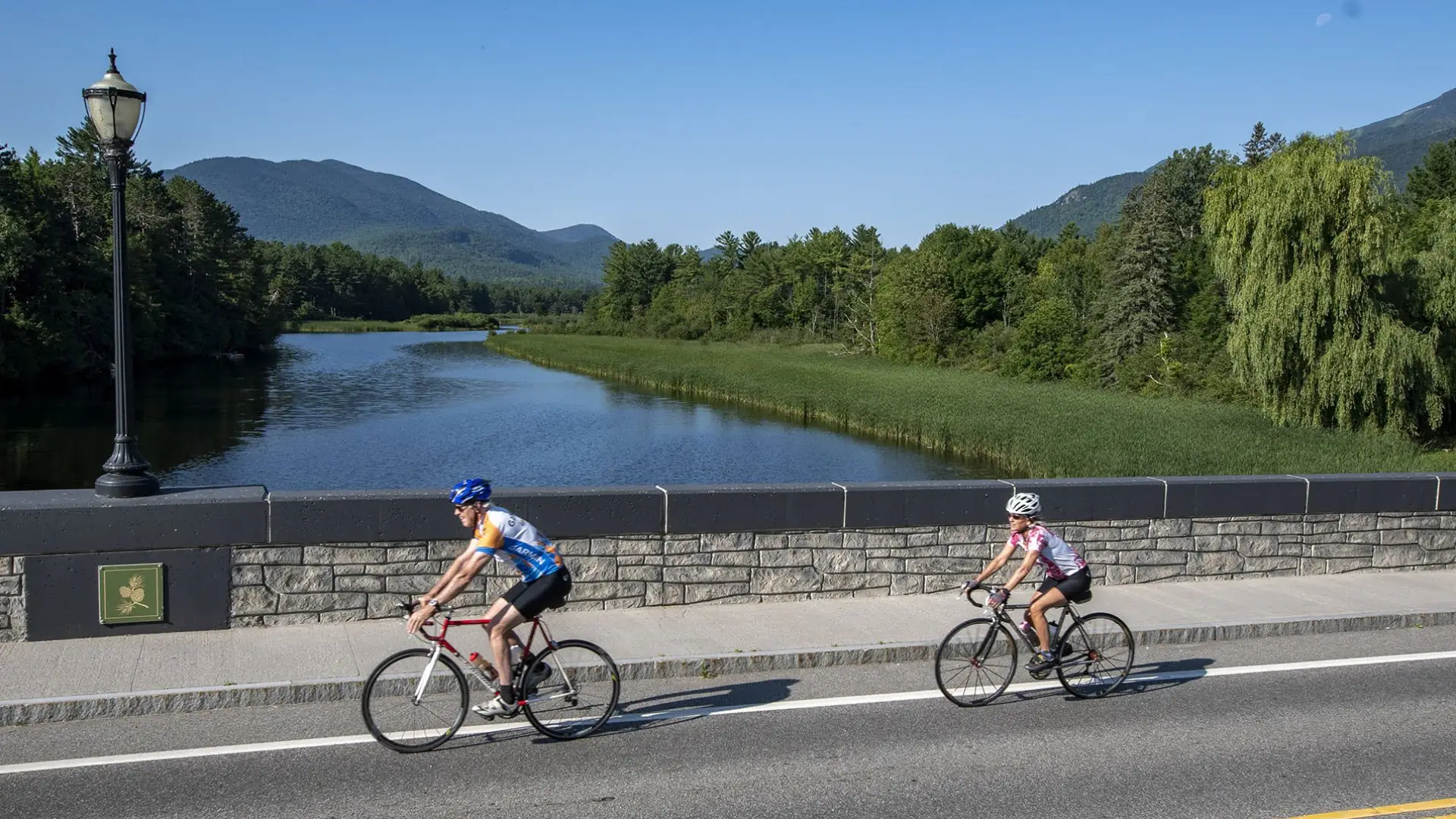 Cyclists crossing bridge over Ausable River
