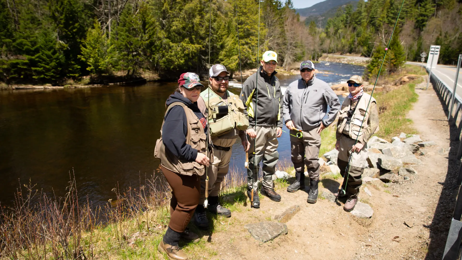 Anglers gather for photo next to river