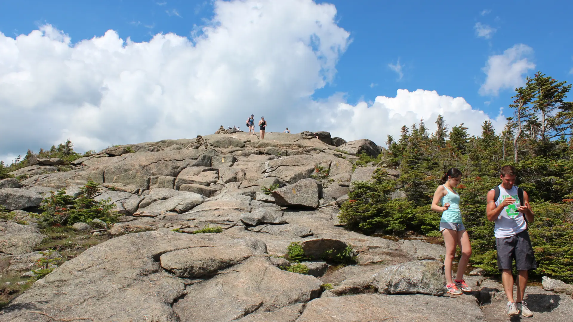 Hikers make their way down Cascade's summit.