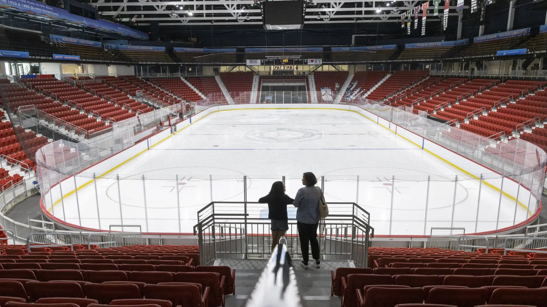 A mother and daughter look out at the remodeled 1980 hockey rink.