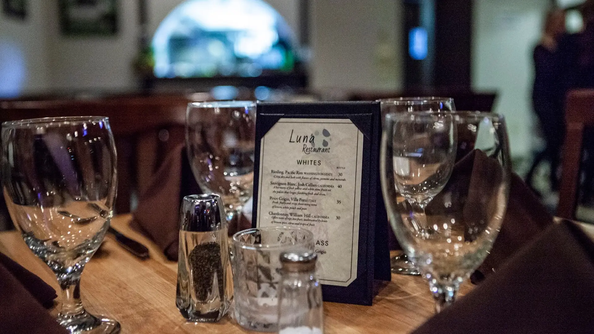 Wine glasses surround Luna Restaurant's drink list.