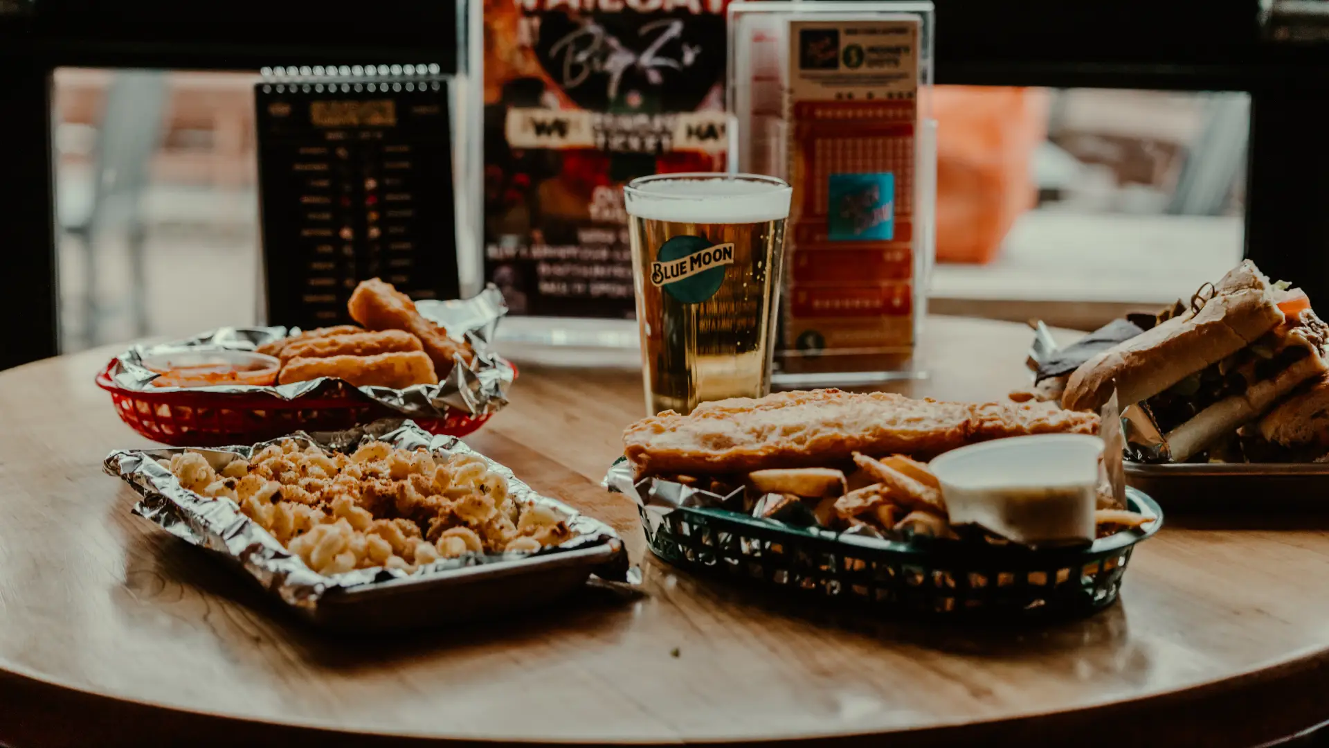 An assortment of foods on a table by the glass garage doors.  Photo Credit to A. Kelly.