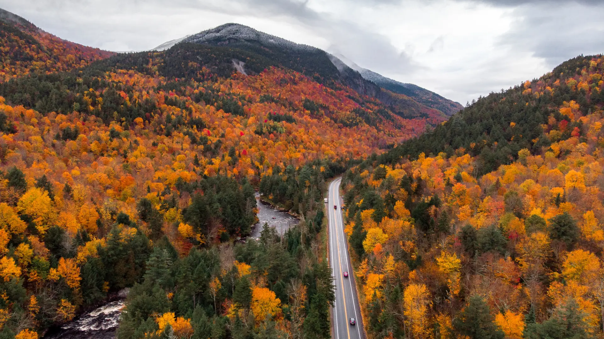 An aerial view of a mountain pass road in the fall