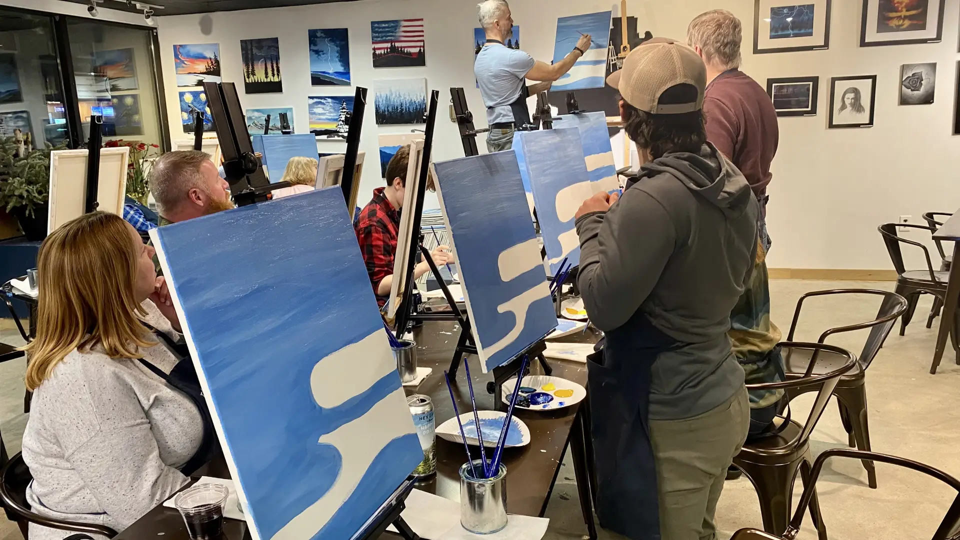 group painting the water on their canvases