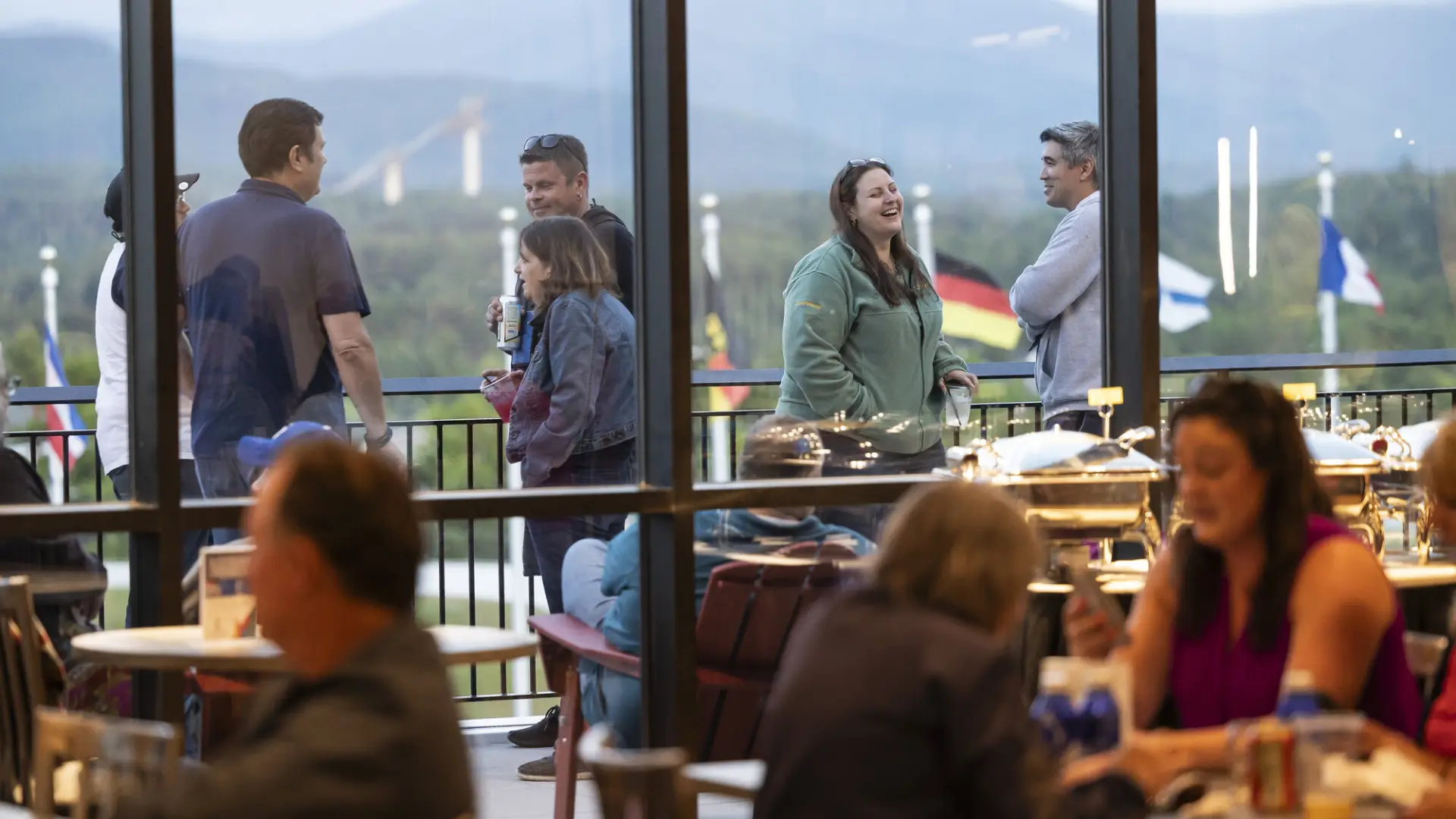 A group of people meet on a deck. 