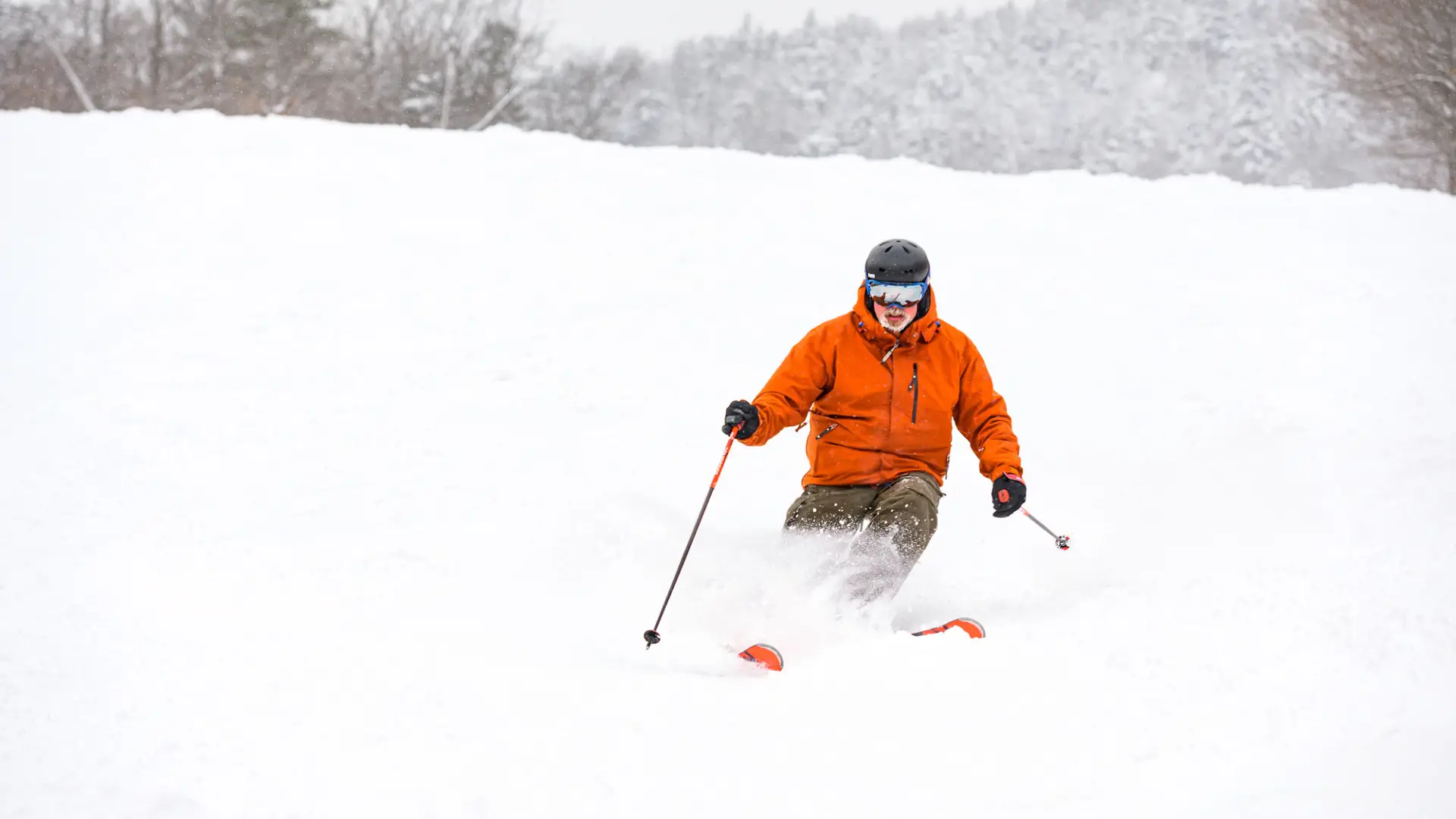 A skier on a snowy trail at Whiteface Mountain.